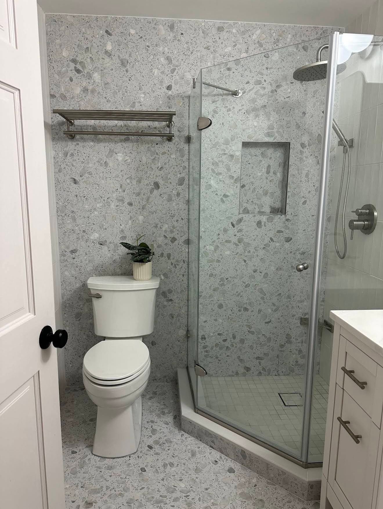 Terrazzo tile shower with rain head and white vanity