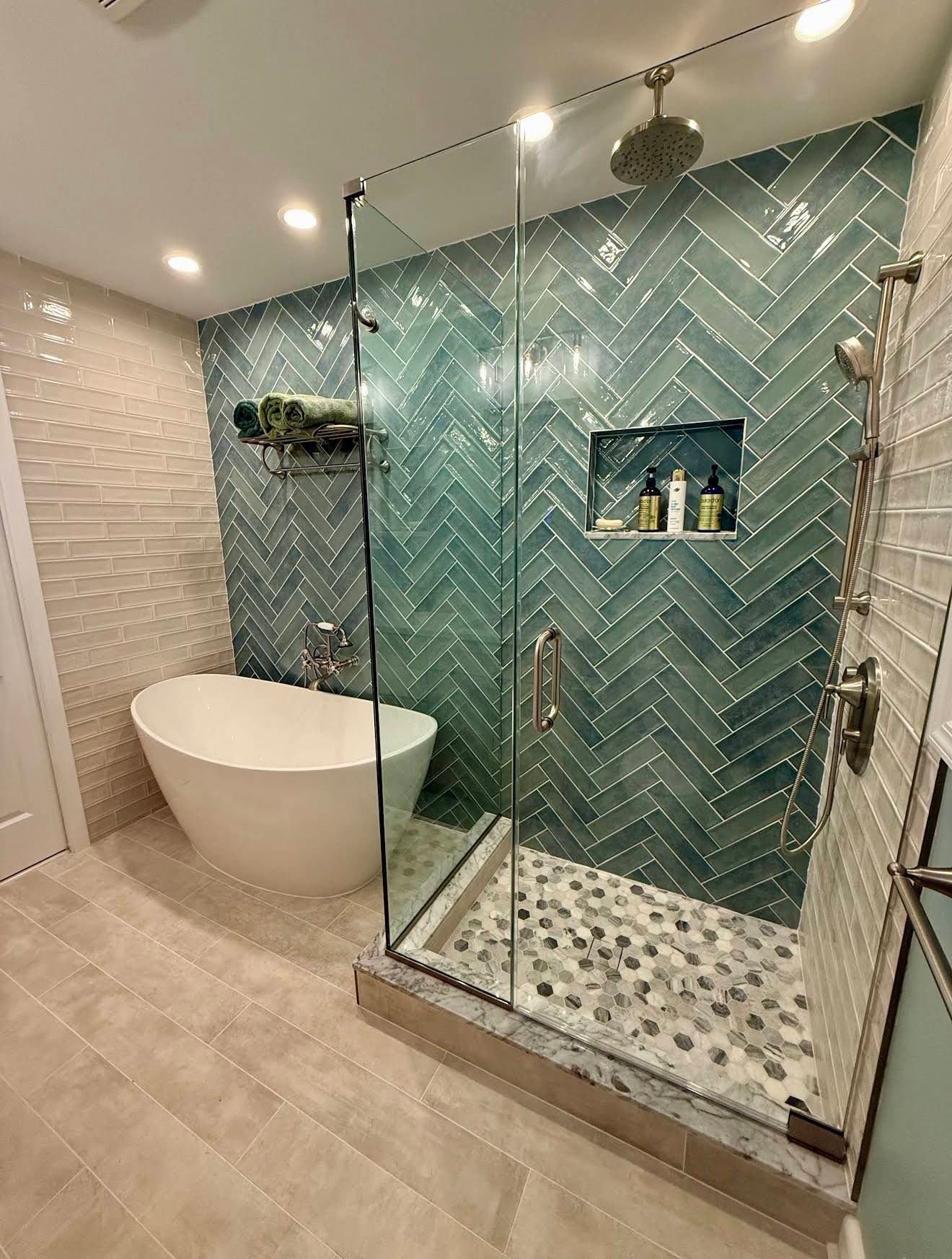 Teal herringbone tile shower with freestanding tub