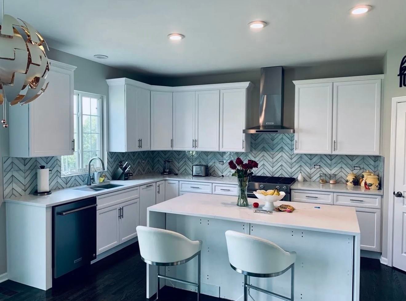 White kitchen remodel with chevron tile backsplash